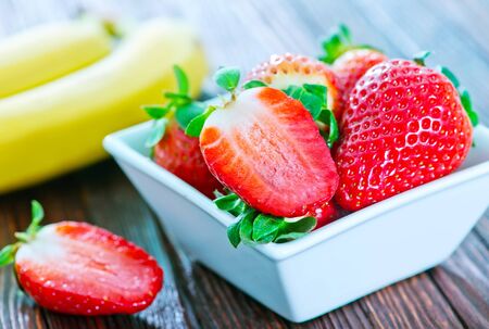 banana and strawberry on the wooden tableの写真素材