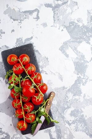 raw tomato, tomato cherry on black boardの写真素材