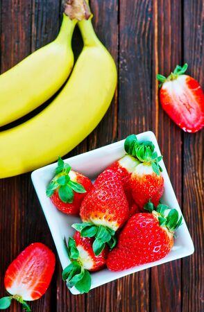 banana and strawberry on the wooden tableの写真素材