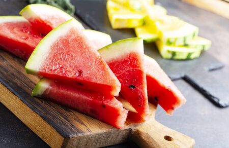 fresh watermelon on board on a tableの写真素材