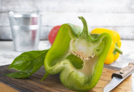 color peppers on wooden board on a tableの写真素材