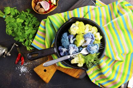 Coloured cauliflowers served on pan.  Purple, white, yellow and cauliflower green. の写真素材