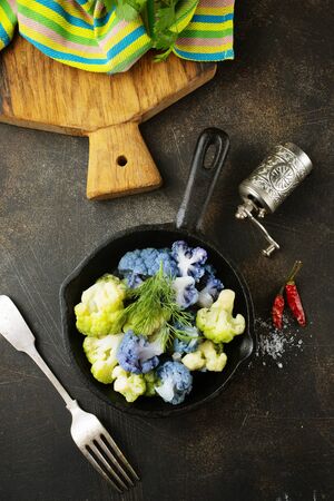 Coloured cauliflowers served on pan.  Purple, white, yellow and cauliflower green.の写真素材