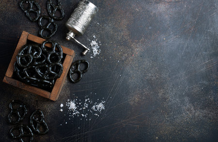 black pretzels in wooden bowl on a table