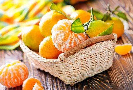 tangerines in basket and on a tableの写真素材