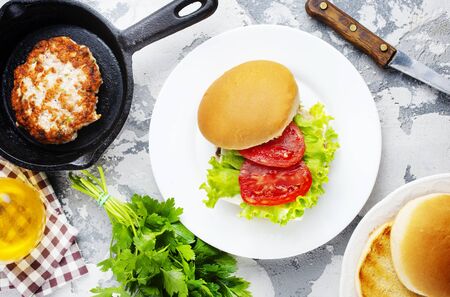 burgers with chicken cutlets on white plateの写真素材