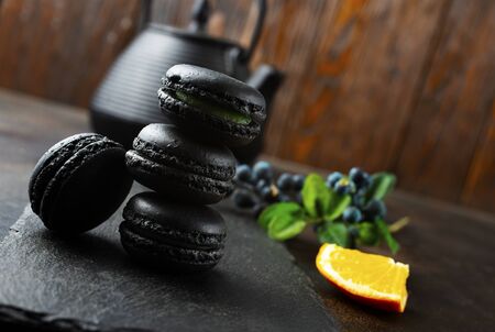 Macaroon cakes on black board. Delicious dessert.の写真素材