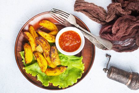fried potato with tomato sauce, baked potatoの写真素材