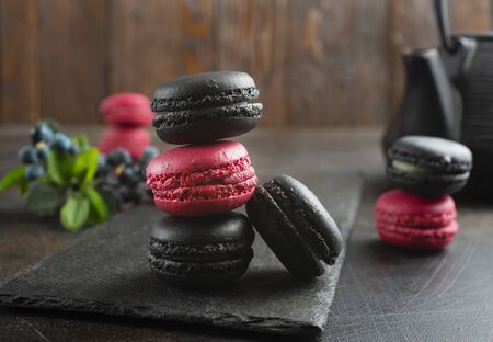 Macaroon cakes on black board. Delicious dessert.の写真素材