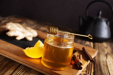 Glass bank with honey ginger lemon and cinnamon.の写真素材