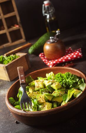salad with avocado and nuts in bowlの写真素材