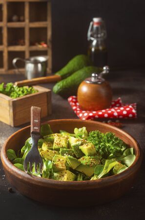 salad with avocado and nuts in bowlの写真素材
