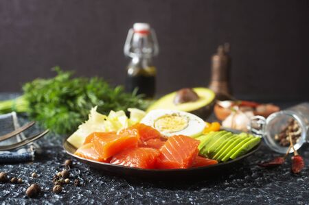 diet food on plate, portion of fresh salmon and avocadoの写真素材