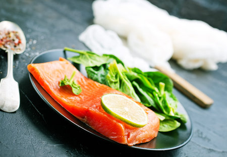 salmon with lemon and fresh spinach, diet food
