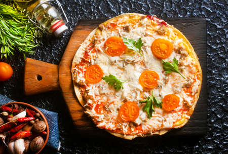 pizza with cheese and tomato, pizza on boardの写真素材