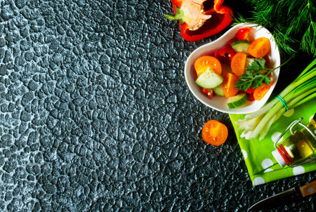 Salad of green cucumber red paprika and yellow tomatoの写真素材