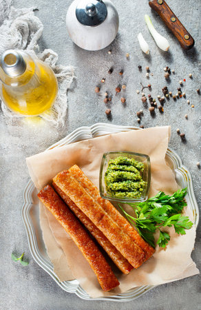 fried sausages with pesta sauce, sausages on plate