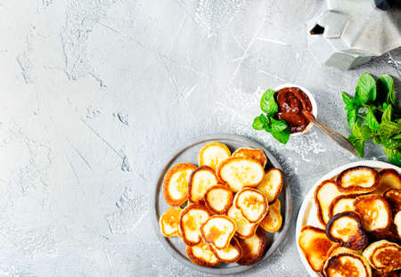 Mini pancakes on plate, top view table scene over a gray background.の写真素材