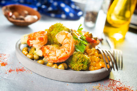 fried shrimps with boiled corn, salad with shrimpsの写真素材
