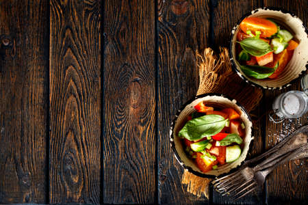 salad with fresh tomato and cucumber in bowlsの写真素材