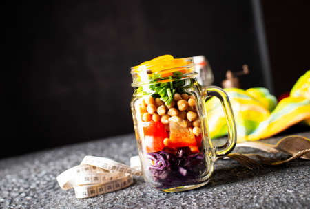 Vegetable salad with chickpeas and red cabbage. Salad in glass bankの写真素材