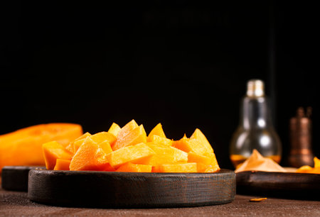 raw pumpkin on wooden plate, fresh pumpkinの写真素材