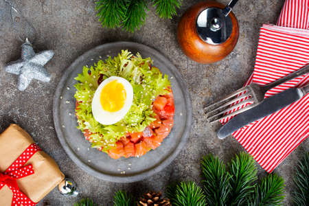 salmon and avocado and cucumber. salad on plateの写真素材