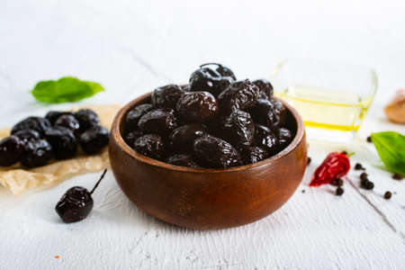 Black olives in bowl. Sun-dried black olives. Top view.の写真素材