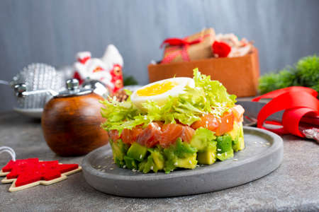 salmon and avocado and cucumber. salad on plateの写真素材