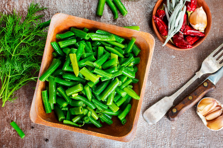 Sauteed green beans with pine nuts in a baking dish, healthy side dish.