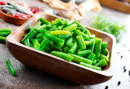 Sauteed green beans with pine nuts in a baking dish, healthy side dish.