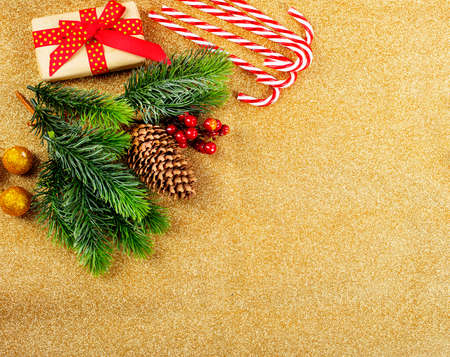 Rich Christmas composition. Lots of objects - candy canes, Christmas balls, cones, candles. Gold backgroundの写真素材