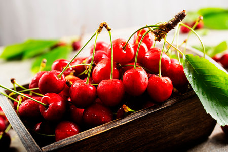 Fresh cherries in bowl on table