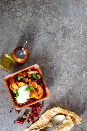 fried meat with vegetables in wooden bowlの写真素材