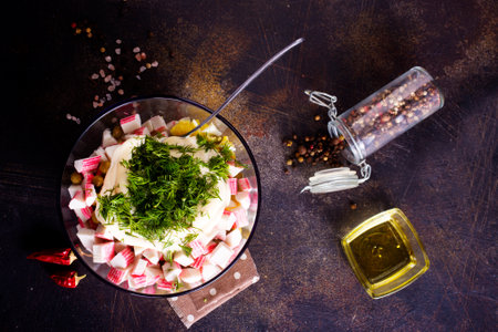 Salad of crab sticks, cheese, garlic and tomatoes, dressed with mayonnaiseの写真素材