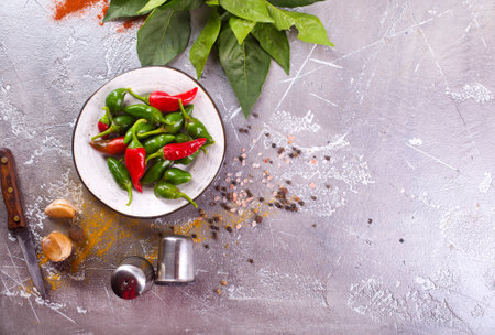 Red and green Chillies on white plateの写真素材