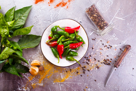Red and green Chillies on white plateの写真素材