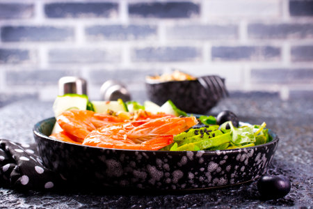Yummy salad with fried shrimps, arugula, avocado and cucumberの写真素材