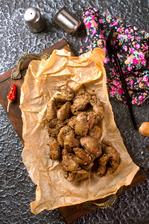 Fried chicken liver with onions and herbs.の写真素材