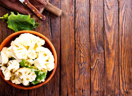 Fresh organic cauliflower cut into small pieces in ceramic bowlの写真素材