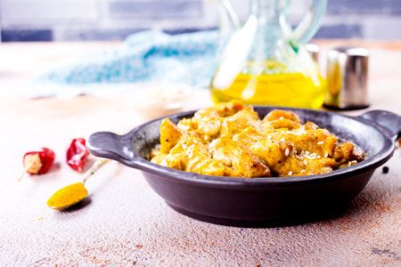 Chicken curry or masala, Kerala style chicken curry using fried coconut in traditional way and arranged in a black ceramic vesselの写真素材