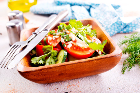 tomato, cucumber and onion salad in wooden bowlの写真素材