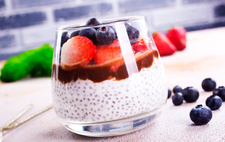 Healthy breakfast, desert, with chia seed pudding, cream, raspberry jam and fresh berriesの写真素材