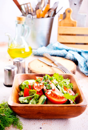 tomato, cucumber and onion salad in wooden bowlの写真素材