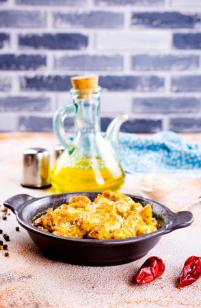 Chicken curry or masala, Kerala style chicken curry using fried coconut in traditional way and arranged in a black ceramic vesselの写真素材