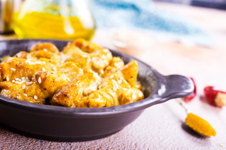 Chicken curry or masala, Kerala style chicken curry using fried coconut in traditional way and arranged in a black ceramic vesselの写真素材