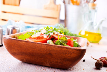 tomato, cucumber and onion salad in wooden bowlの写真素材