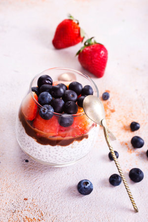 Healthy breakfast, desert, with chia seed pudding, cream, raspberry jam and fresh berriesの写真素材