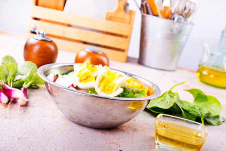 Bowl of vegetarian salad with boiled eggs- radishes- cucumbers- corn saladの写真素材