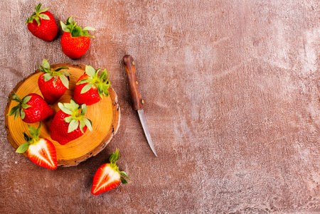 Fresh strawberries on wooden board on a tableの写真素材